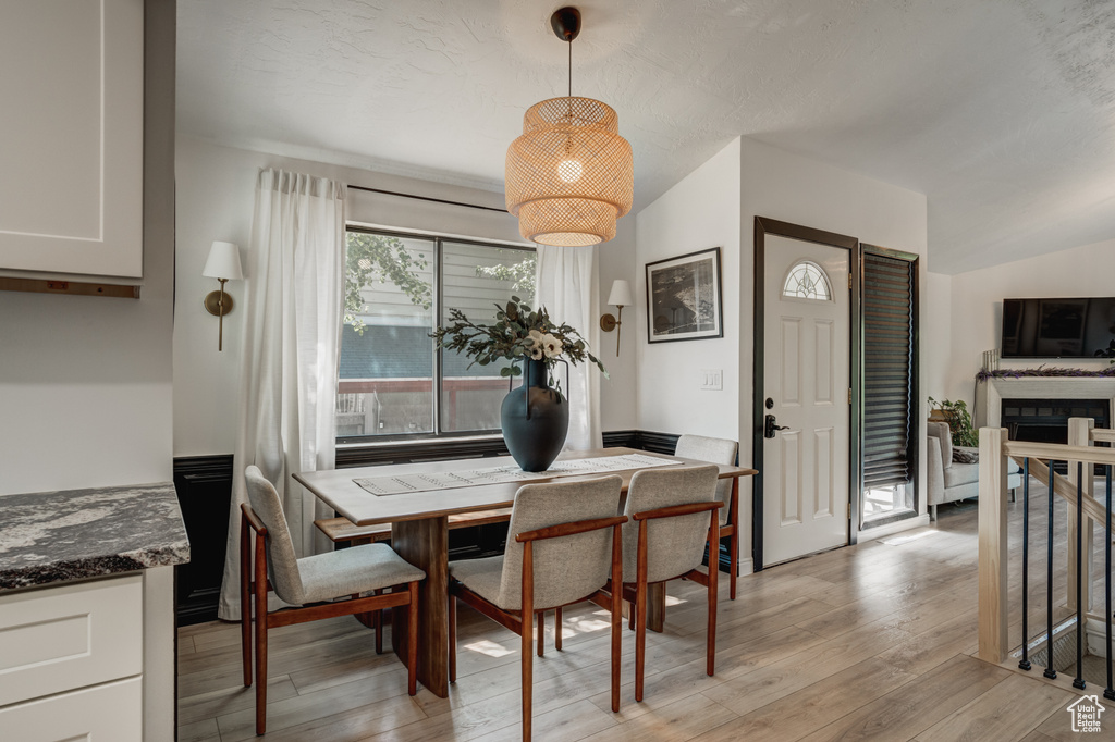 Dining room featuring lofted ceiling and light wood-type flooring