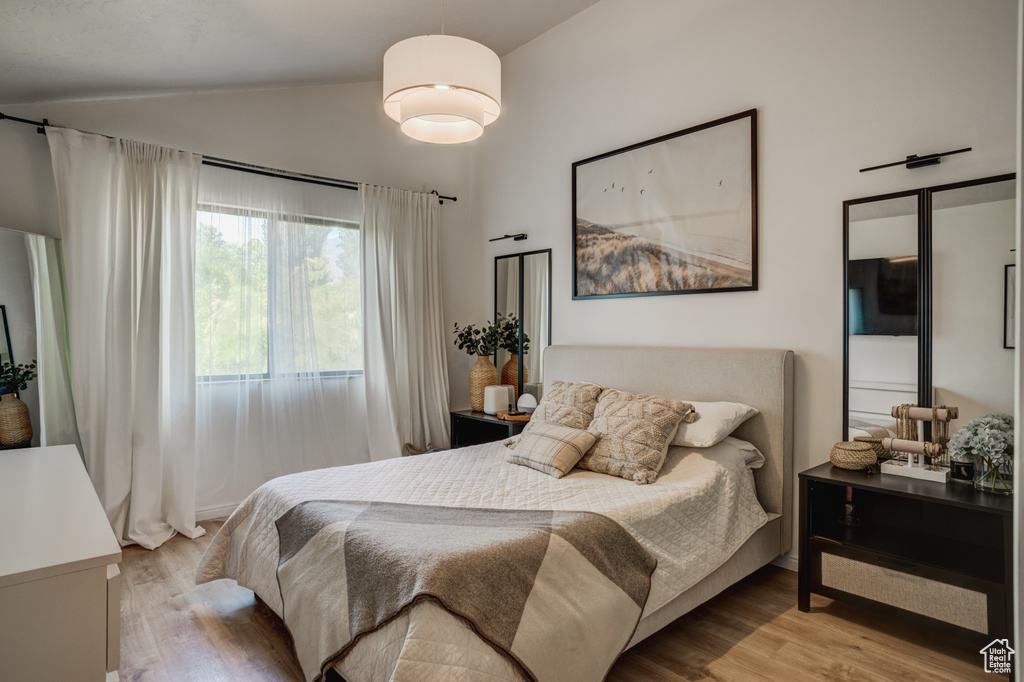 Bedroom featuring light hardwood / wood-style flooring and lofted ceiling