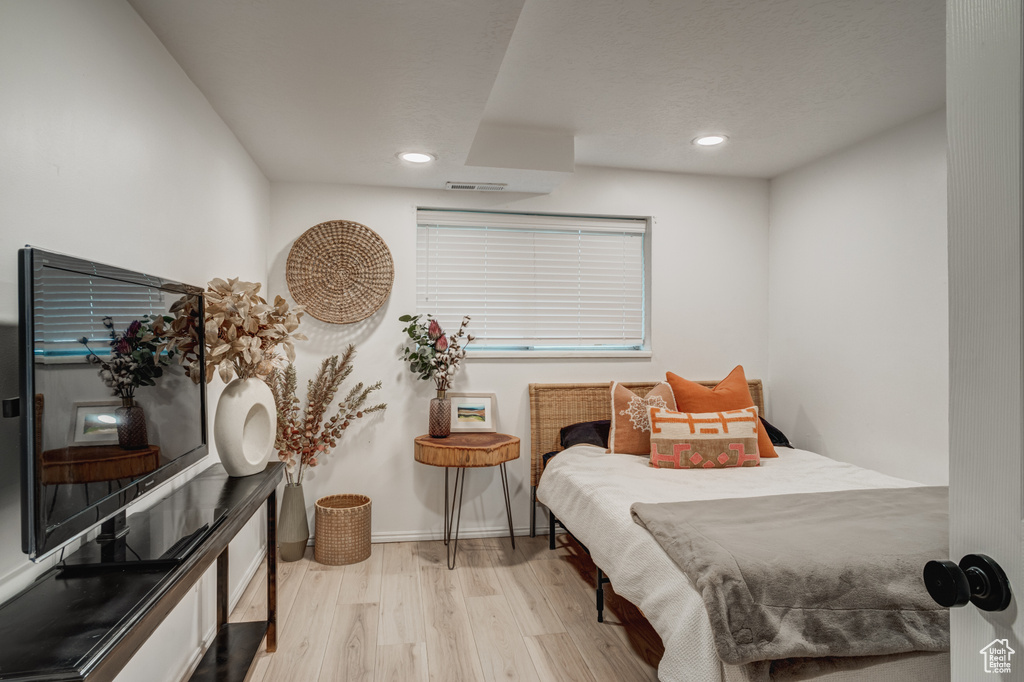 Bedroom with light hardwood / wood-style flooring