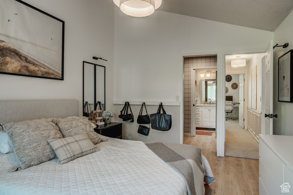 Carpeted bedroom with lofted ceiling and ensuite bath