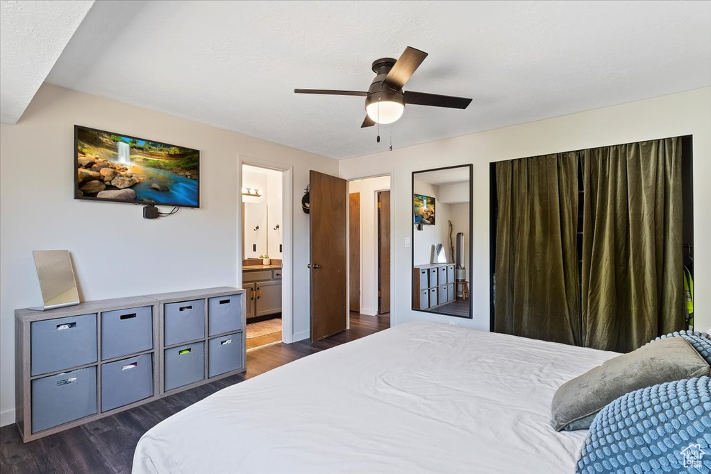 Bedroom featuring ensuite bath, ceiling fan, and dark hardwood / wood-style flooring