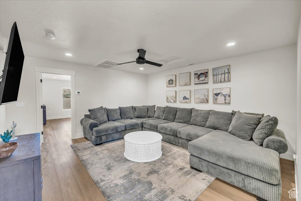 Living room featuring light hardwood / wood-style flooring and ceiling fan