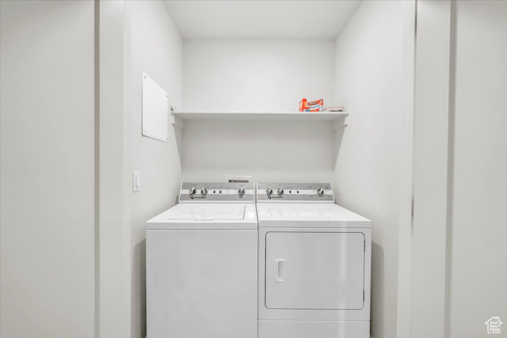 Clothes washing area featuring washing machine and clothes dryer