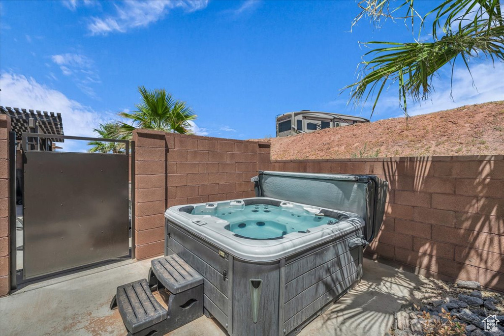 View of patio featuring a hot tub