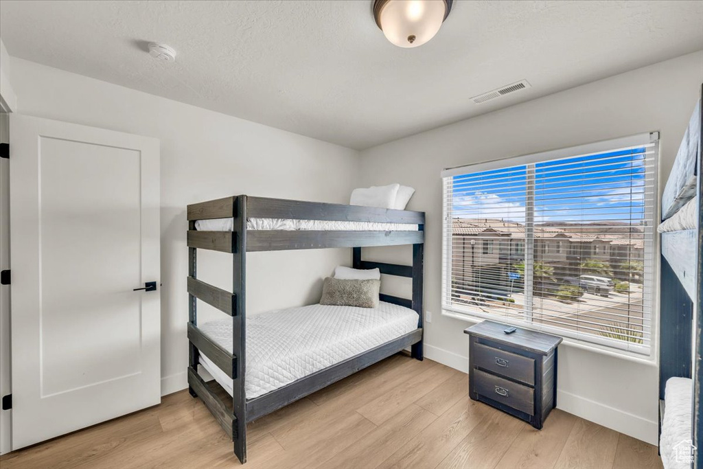 Bedroom with light hardwood / wood-style floors