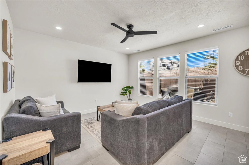 Living room featuring ceiling fan and light tile patterned floors