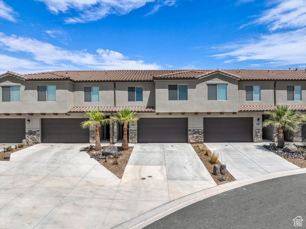 Mediterranean / spanish house featuring a garage