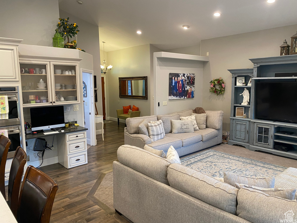 Living room featuring an inviting chandelier and dark hardwood / wood-style floors