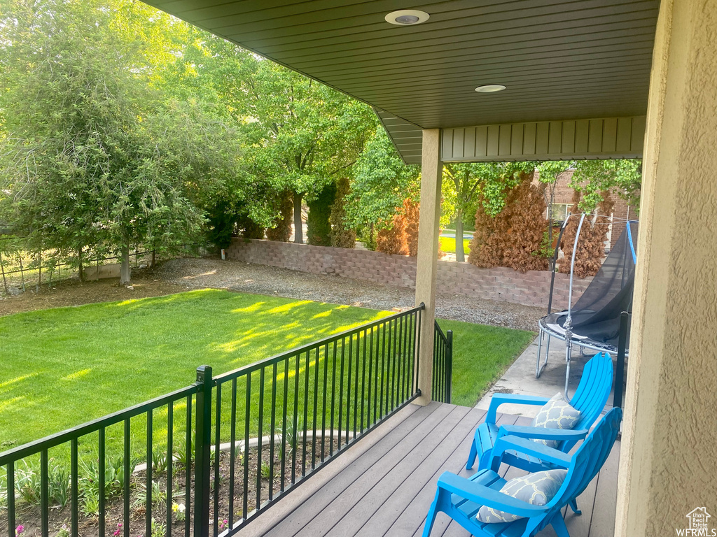 Wooden terrace featuring a lawn