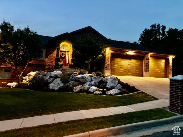 View of front of property with a garage and a front yard