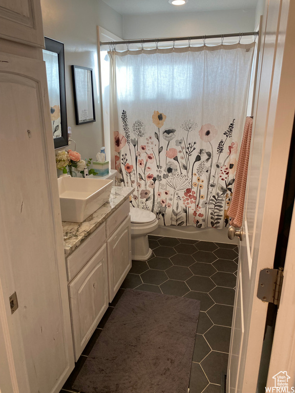 Bathroom with vanity, toilet, and tile patterned floors