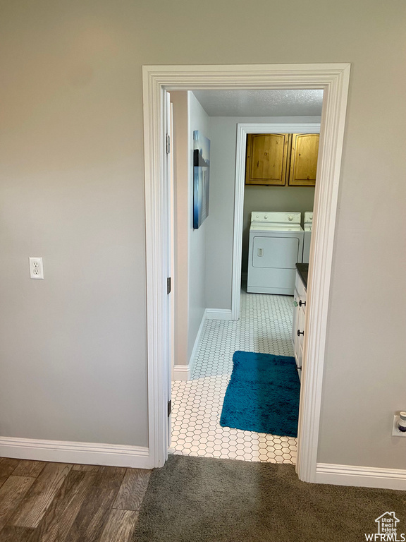 Bathroom featuring washer and dryer and tile patterned floors