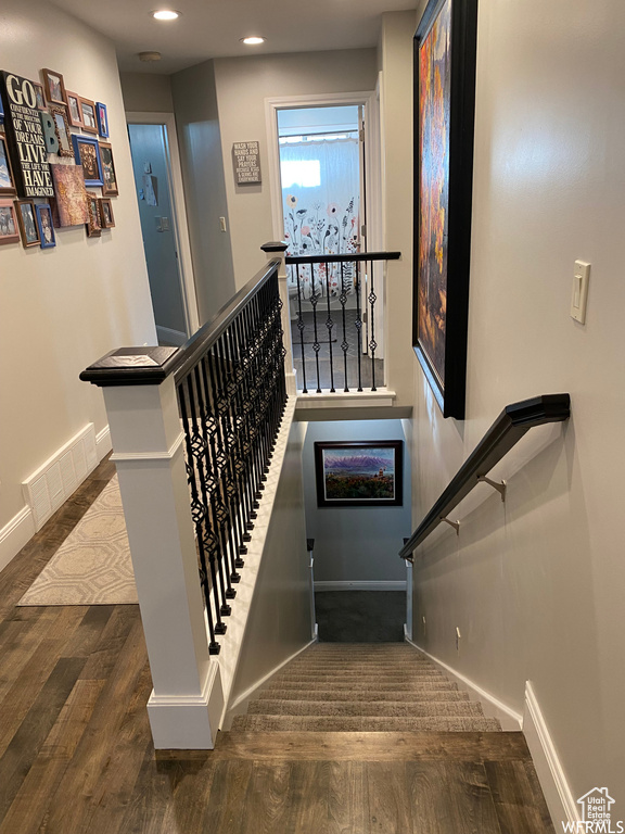 Staircase featuring dark hardwood / wood-style floors