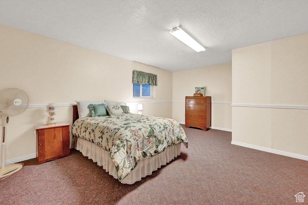 Carpeted bedroom with a textured ceiling