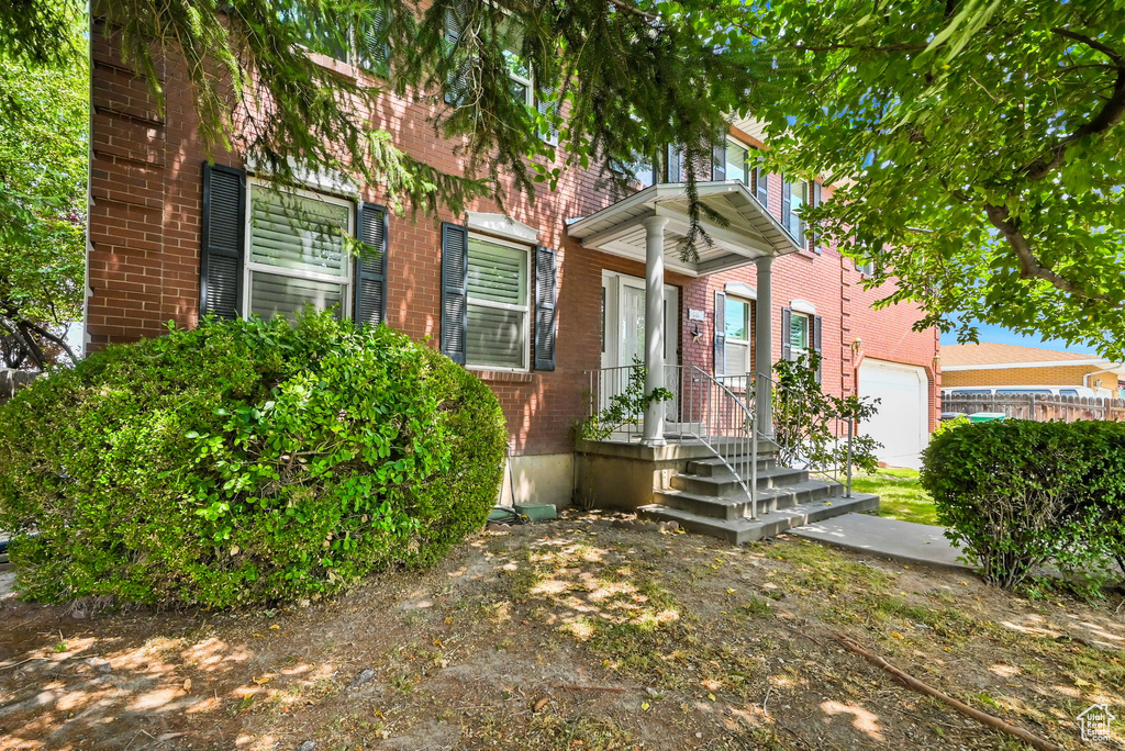 View of exterior entry with a garage