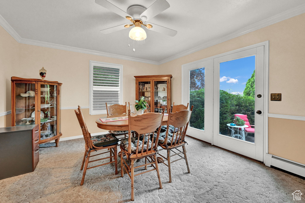 Dining area featuring a healthy amount of sunlight and crown molding