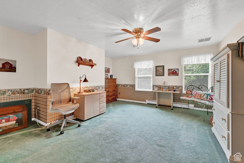 Sitting room with a baseboard radiator, carpet flooring, a textured ceiling, and ceiling fan