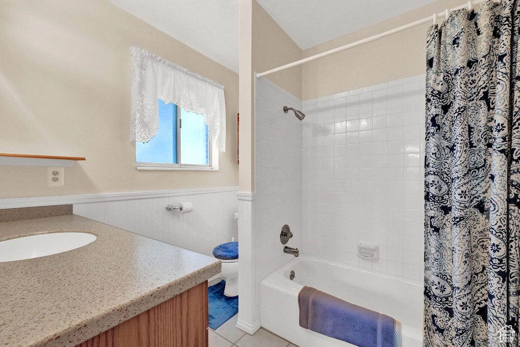 Full bathroom featuring vanity, tile patterned flooring, toilet, and shower / bath combo