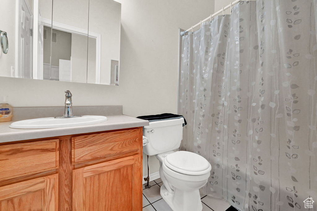 Bathroom with tile patterned floors, toilet, and vanity