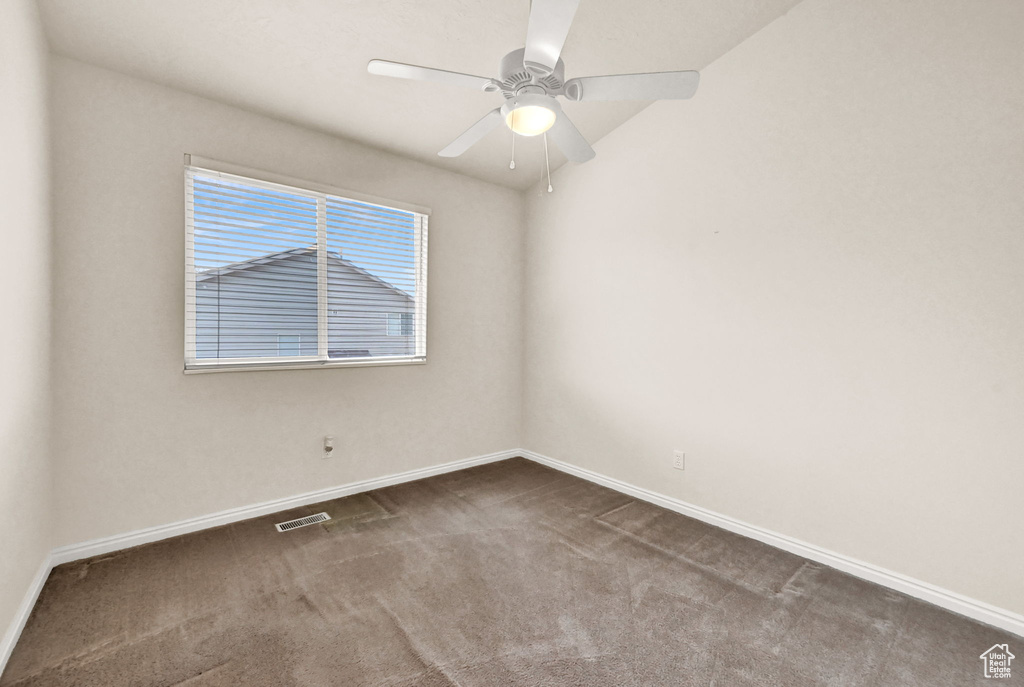 Empty room featuring carpet floors and ceiling fan