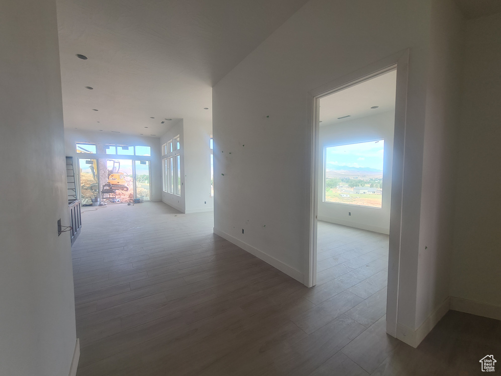 Corridor with hardwood / wood-style floors