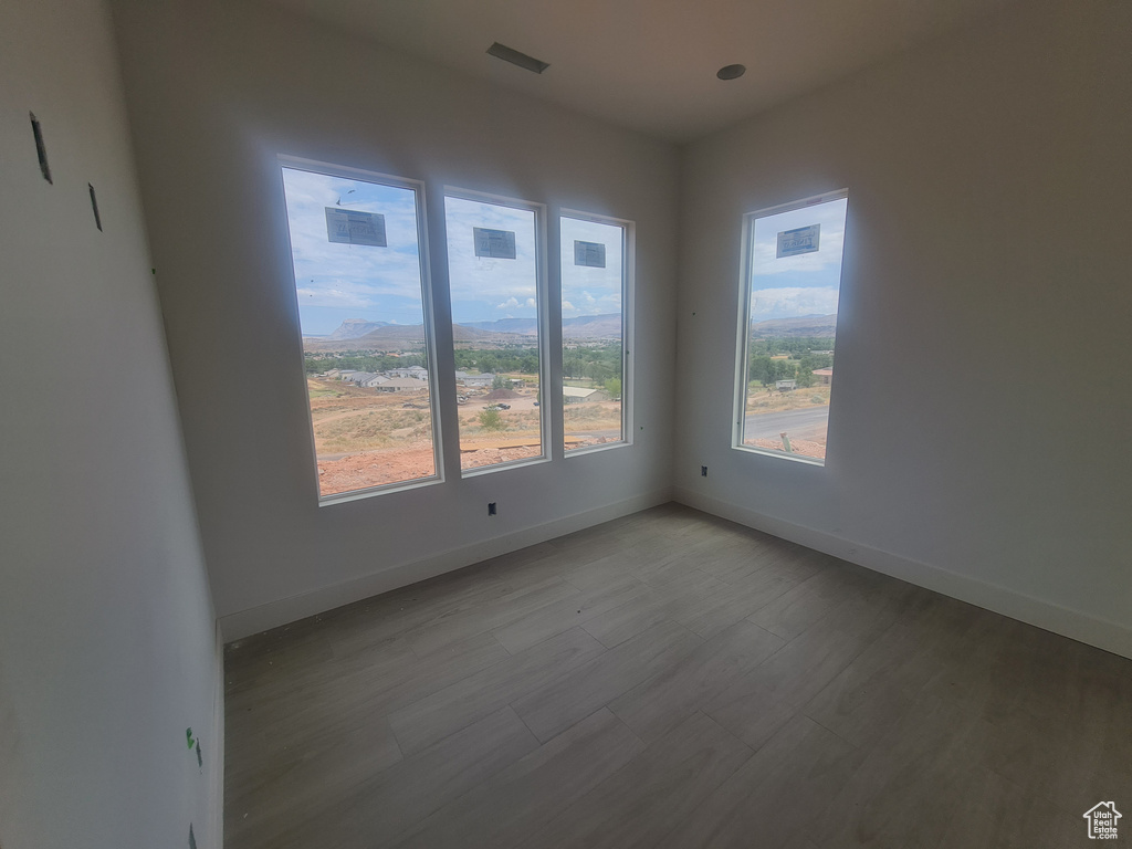 Unfurnished room featuring hardwood / wood-style floors