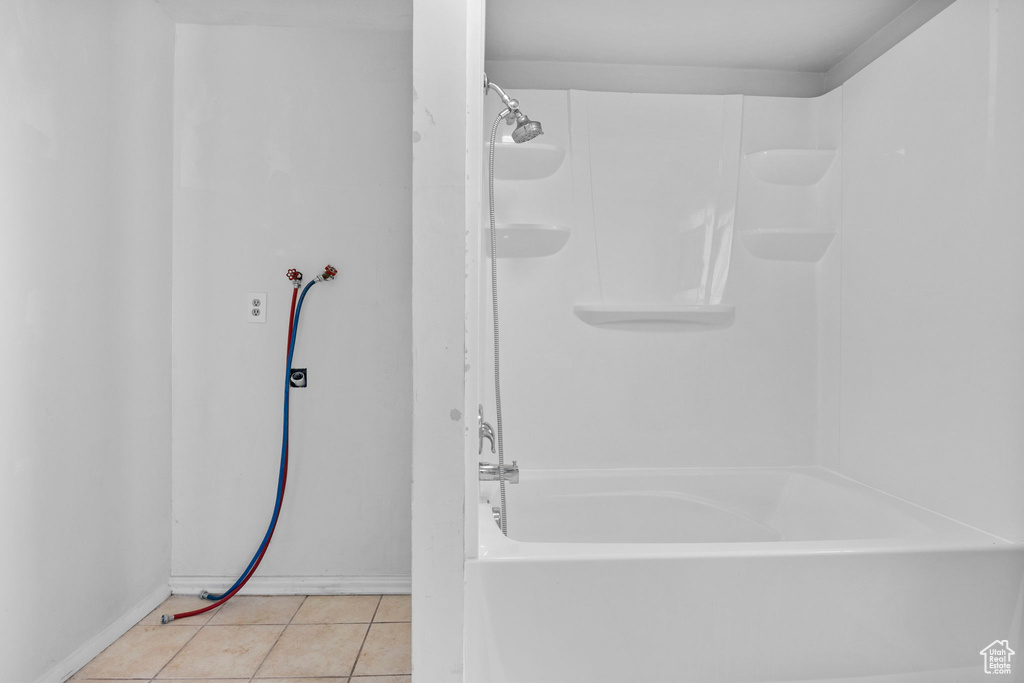 Bathroom with tub / shower combination and tile patterned floors