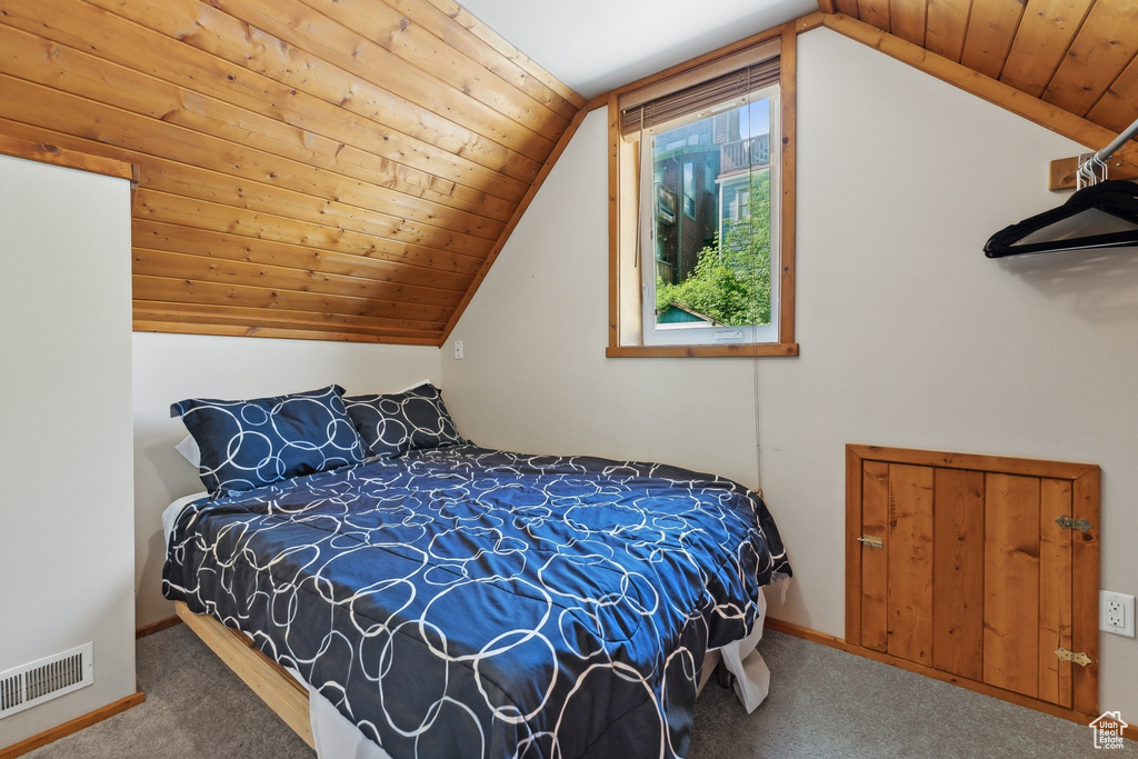 Bedroom with wooden ceiling and vaulted ceiling