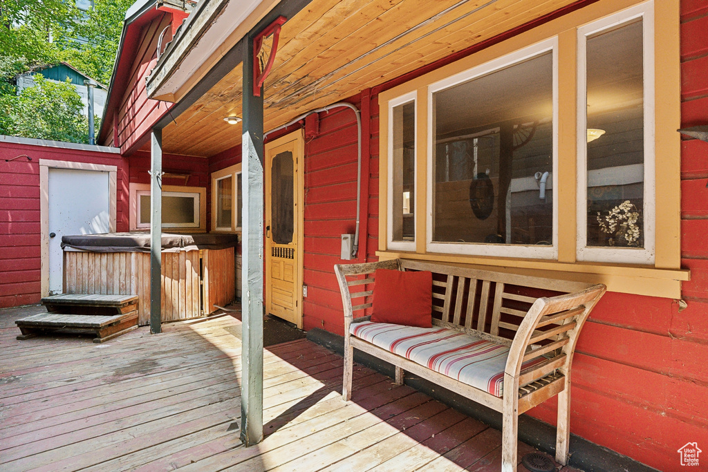 Wooden terrace featuring a hot tub