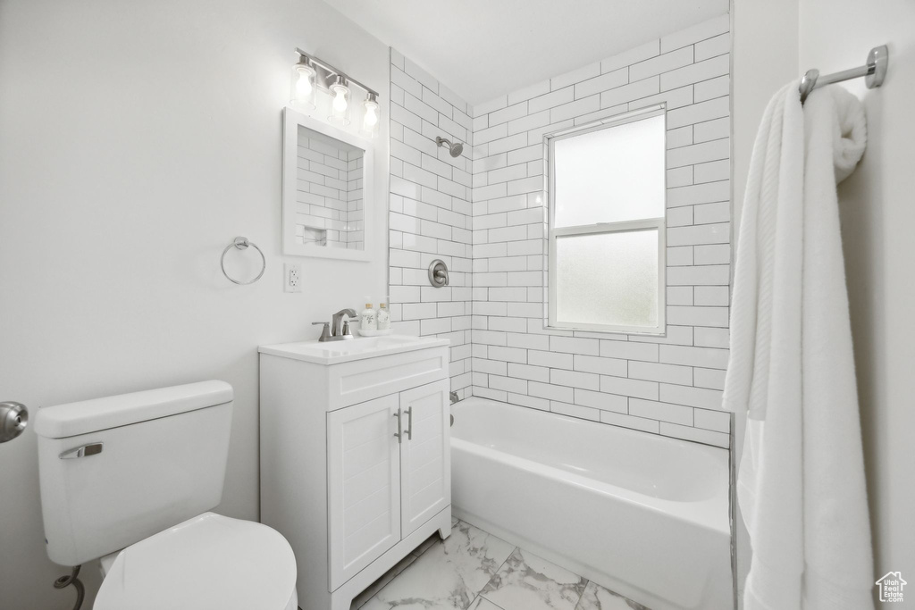 Full bathroom featuring vanity, shower / bathtub combination with curtain, tile patterned flooring, and toilet