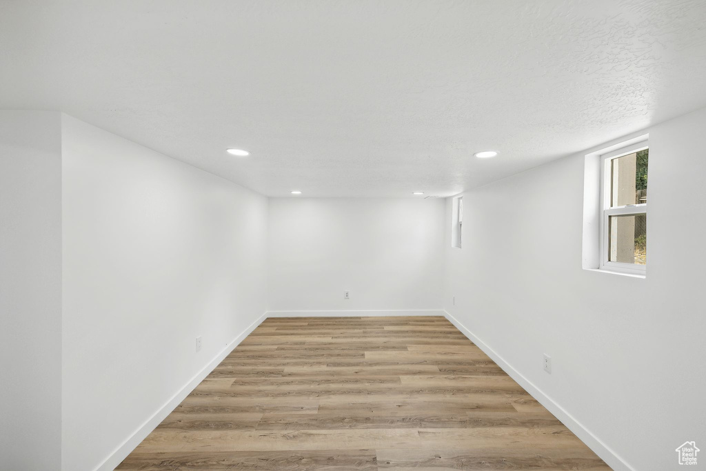 Spare room with a textured ceiling and light wood-type flooring