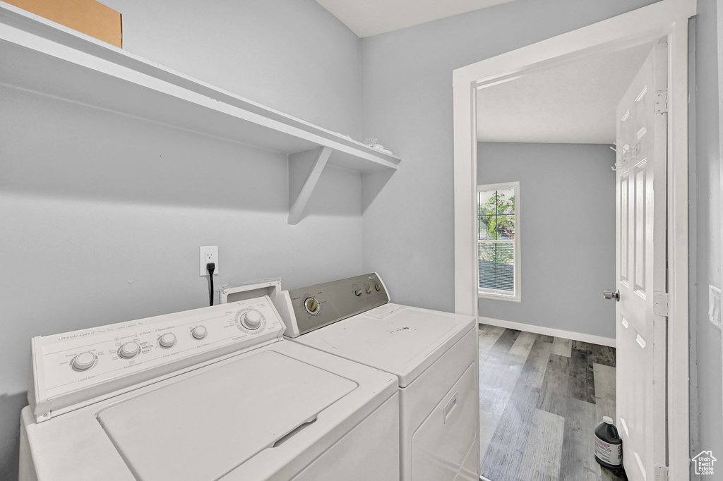 Laundry area featuring washer and dryer and light wood-type flooring