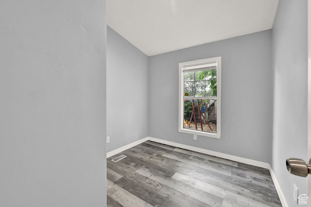 Spare room featuring hardwood / wood-style flooring