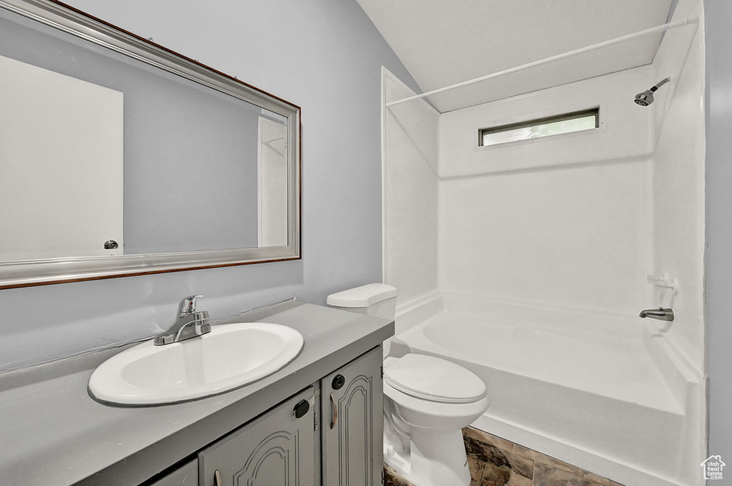 Full bathroom with tub / shower combination, vanity, and toilet