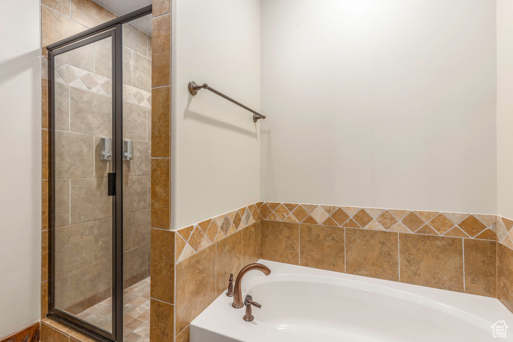 Bathroom with a garden tub and a stall shower