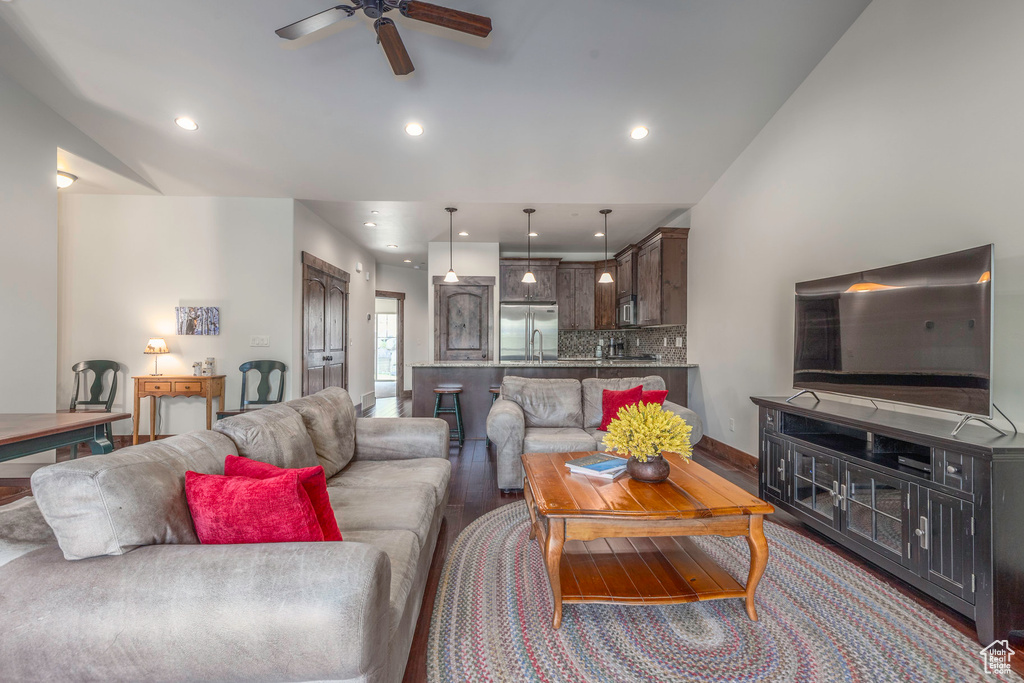 Living room featuring ceiling fan, wood finished floors, and recessed lighting