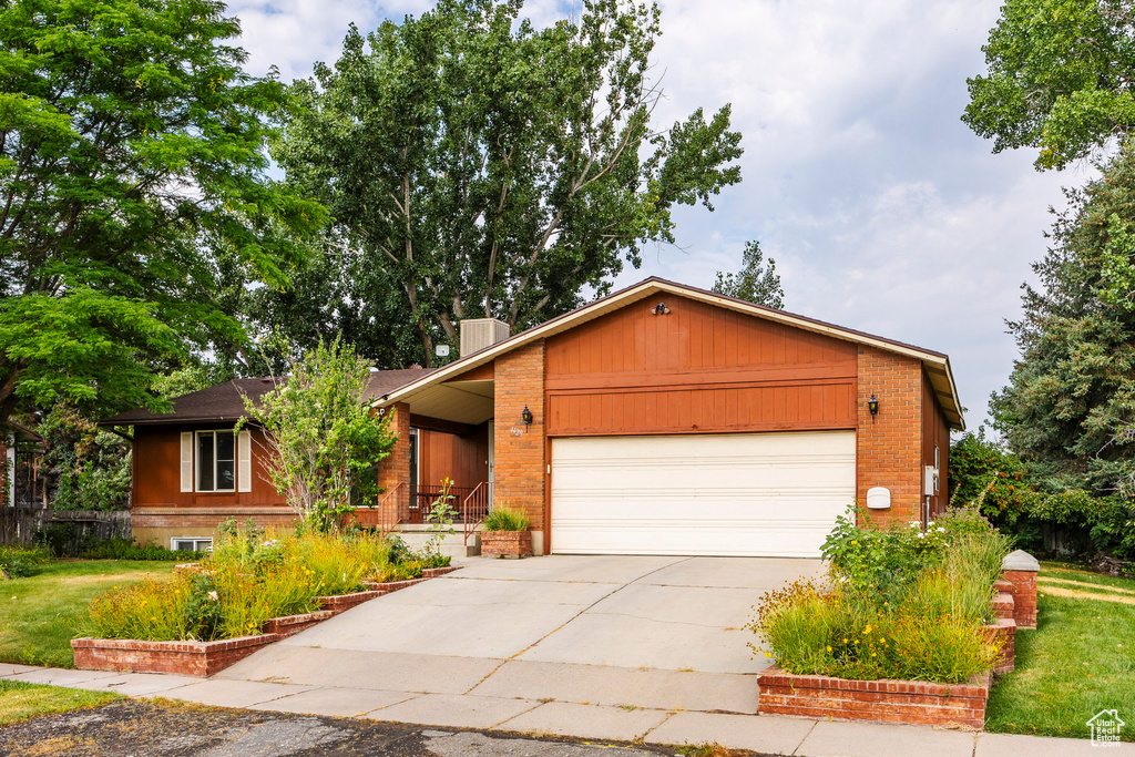 Ranch-style house with a garage and a front yard