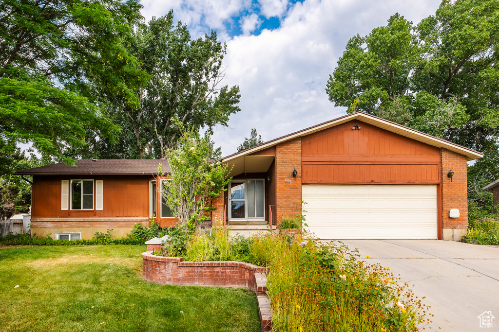 Ranch-style house with a garage and a front yard