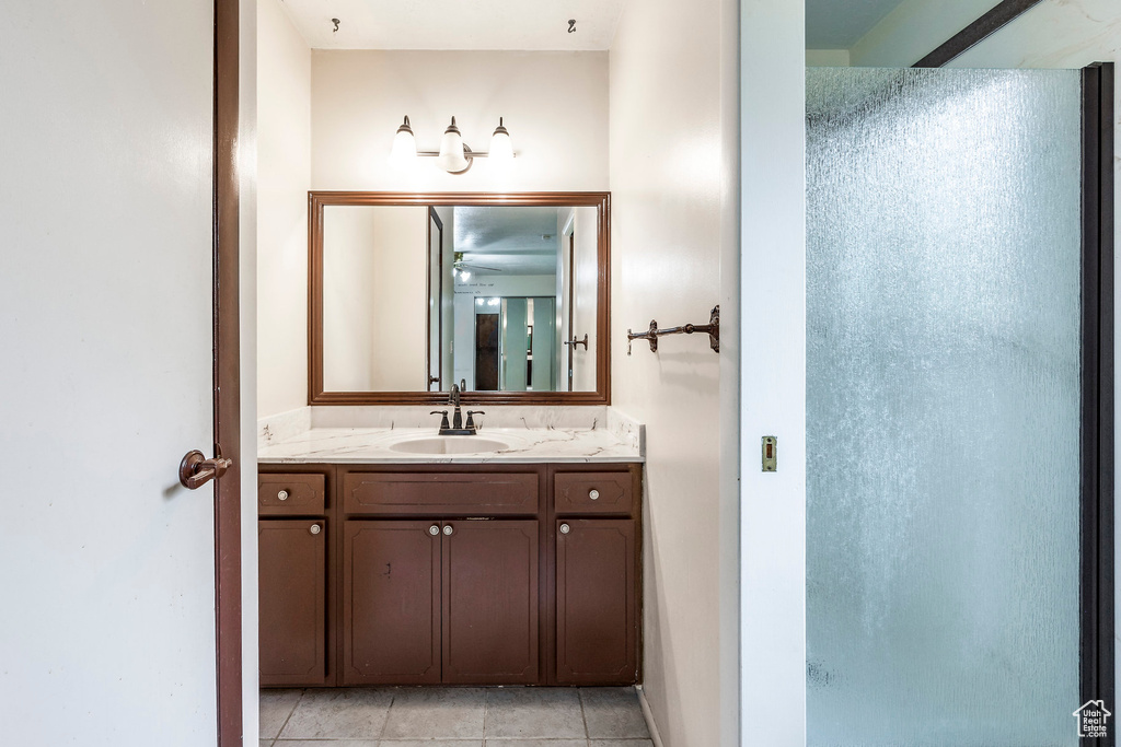 Bathroom with tile patterned floors and vanity