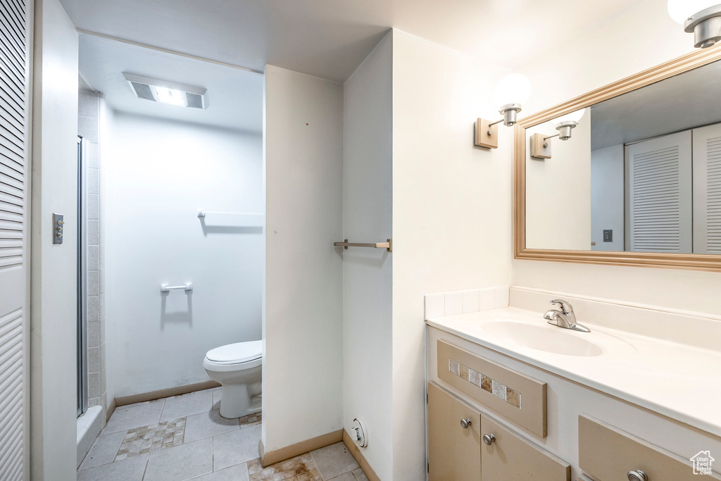 Bathroom with vanity, tile patterned flooring, and toilet