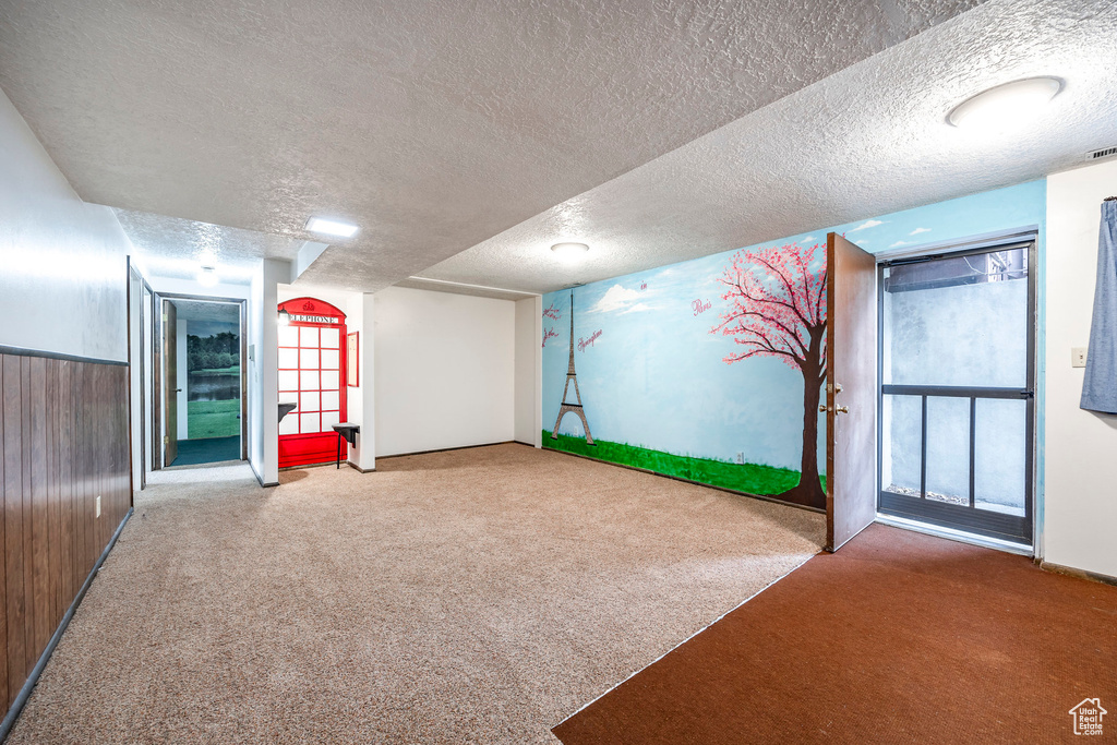 Playroom featuring carpet and a textured ceiling