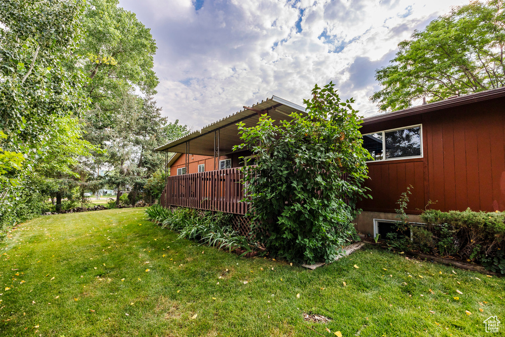 View of yard with a wooden deck