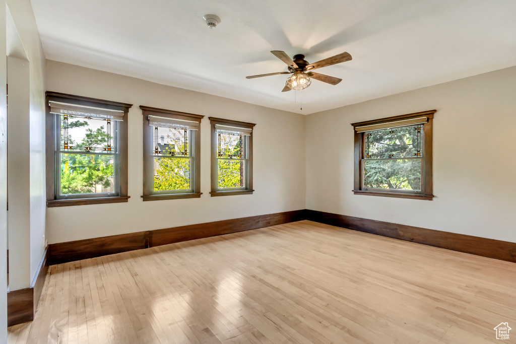 Unfurnished room featuring ceiling fan and light hardwood / wood-style flooring