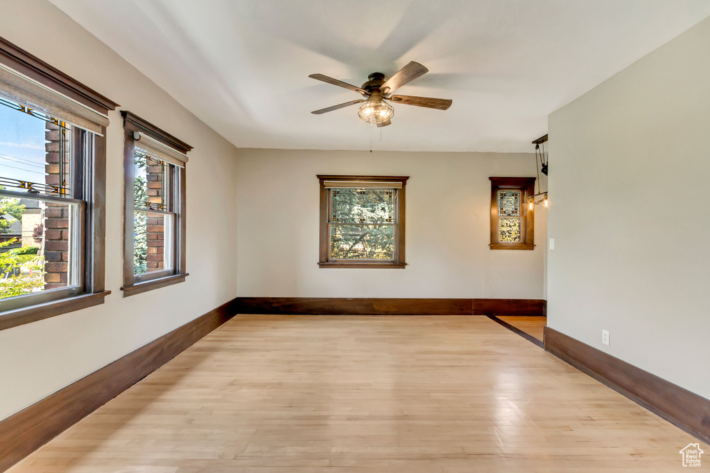 Unfurnished room featuring light wood-type flooring and ceiling fan