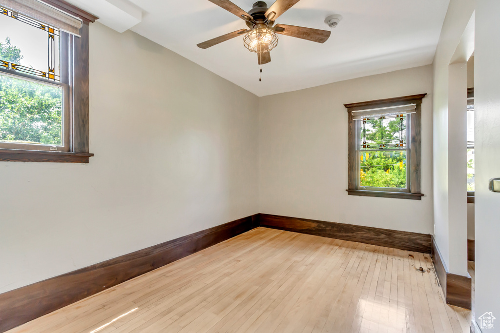 Spare room with wood-type flooring and ceiling fan