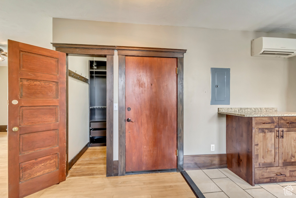 Interior space featuring a wall mounted AC and electric panel