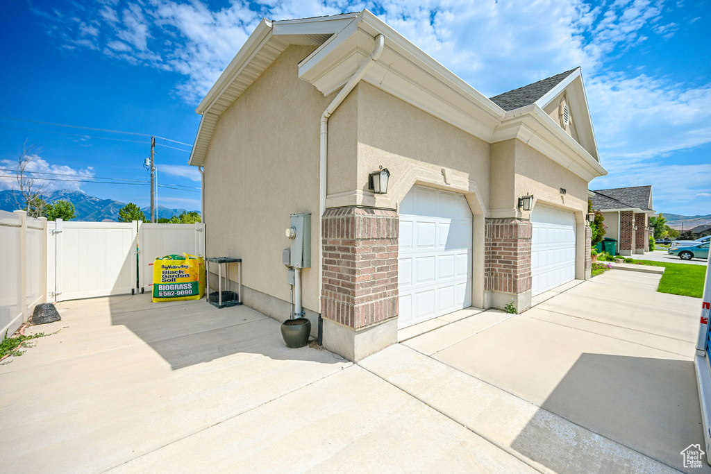 View of side of home featuring a garage