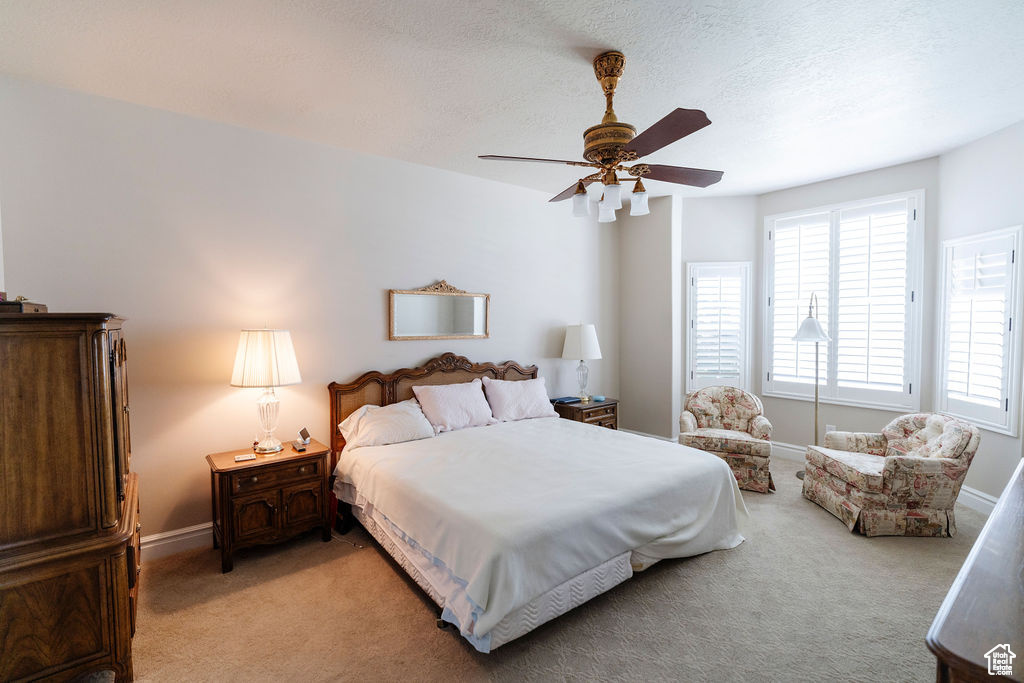 Bedroom featuring light carpet and ceiling fan