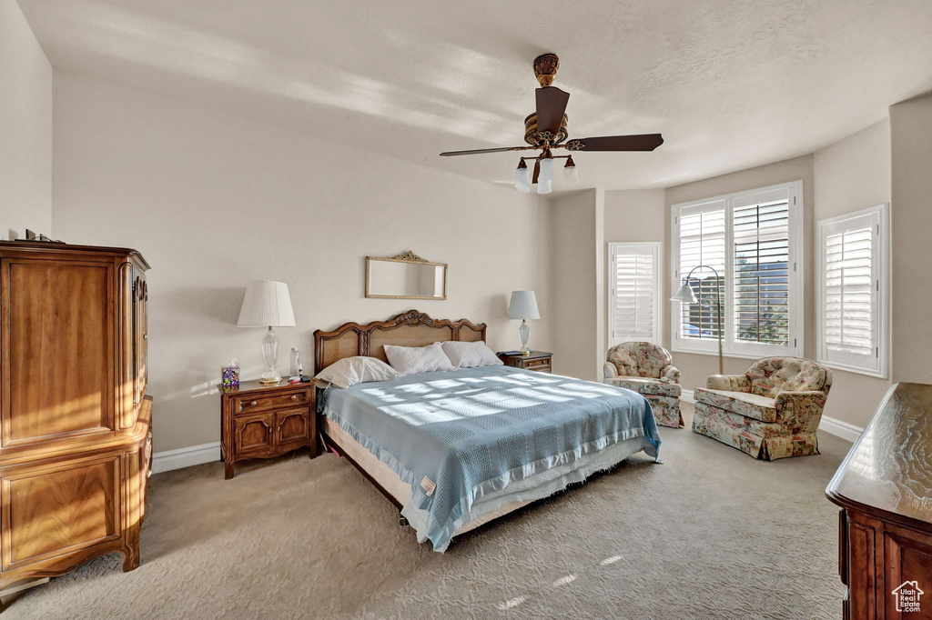 Bedroom with light colored carpet and ceiling fan