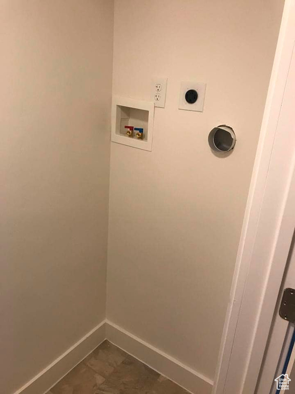 Clothes washing area featuring hookup for an electric dryer, tile patterned flooring, and hookup for a washing machine